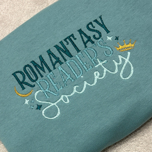 Romantasy Readers Society text on a teal coloured sweatshirt