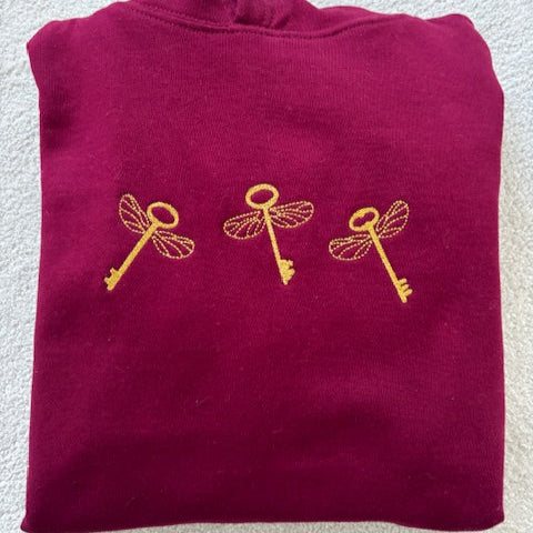 Embroidered flying keys on burgundy cotton blend sweatshirt