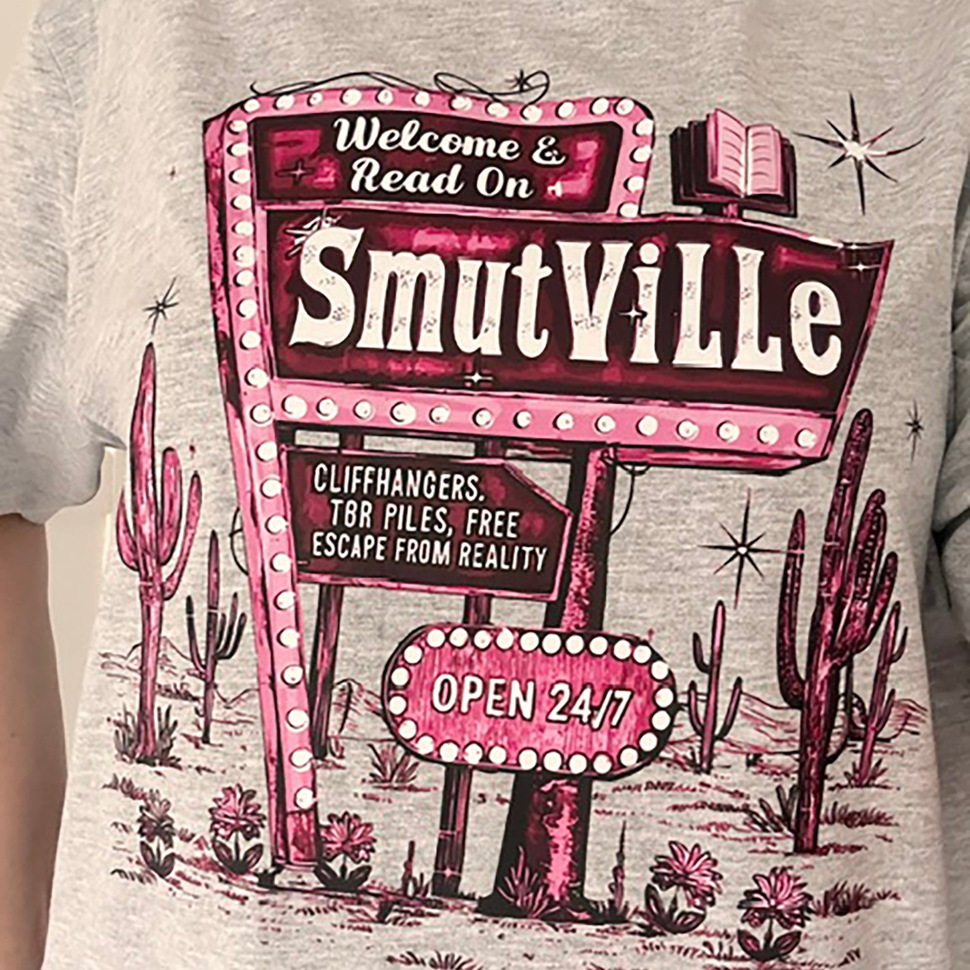 T-shirt with 'Smutville' sign design featuring cacti and desert elements.