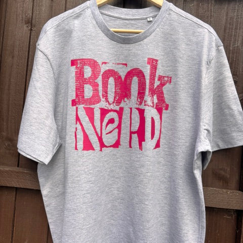 Grey sweatshirt with 'Book Nerd' in pink text on a wooden surface