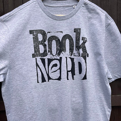 Grey t-shirt with 'Book Nerd' text on a wooden background