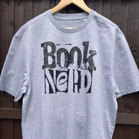 Grey t-shirt with 'Book Nerd' graphic against a wooden background
