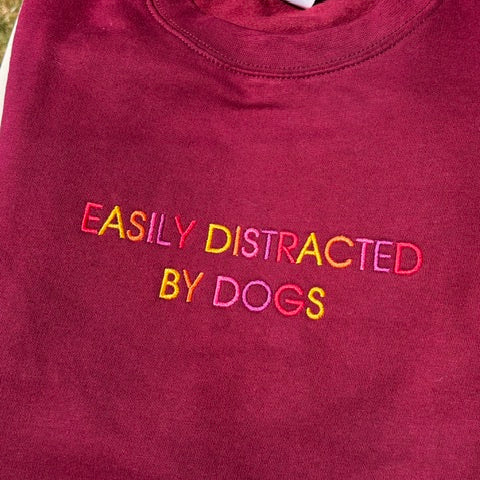 Easily distracted by Dogs on a burgundy sweatshirt