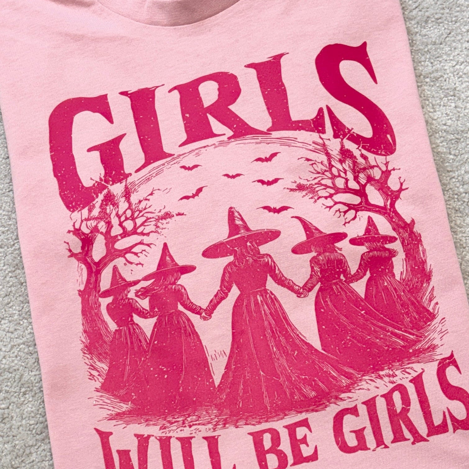 Bright pink print of Girls will be Girls printed on pale pink t-shirt
