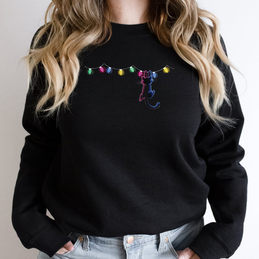 Black sweatshirt with colorful embroidered design on a plain background