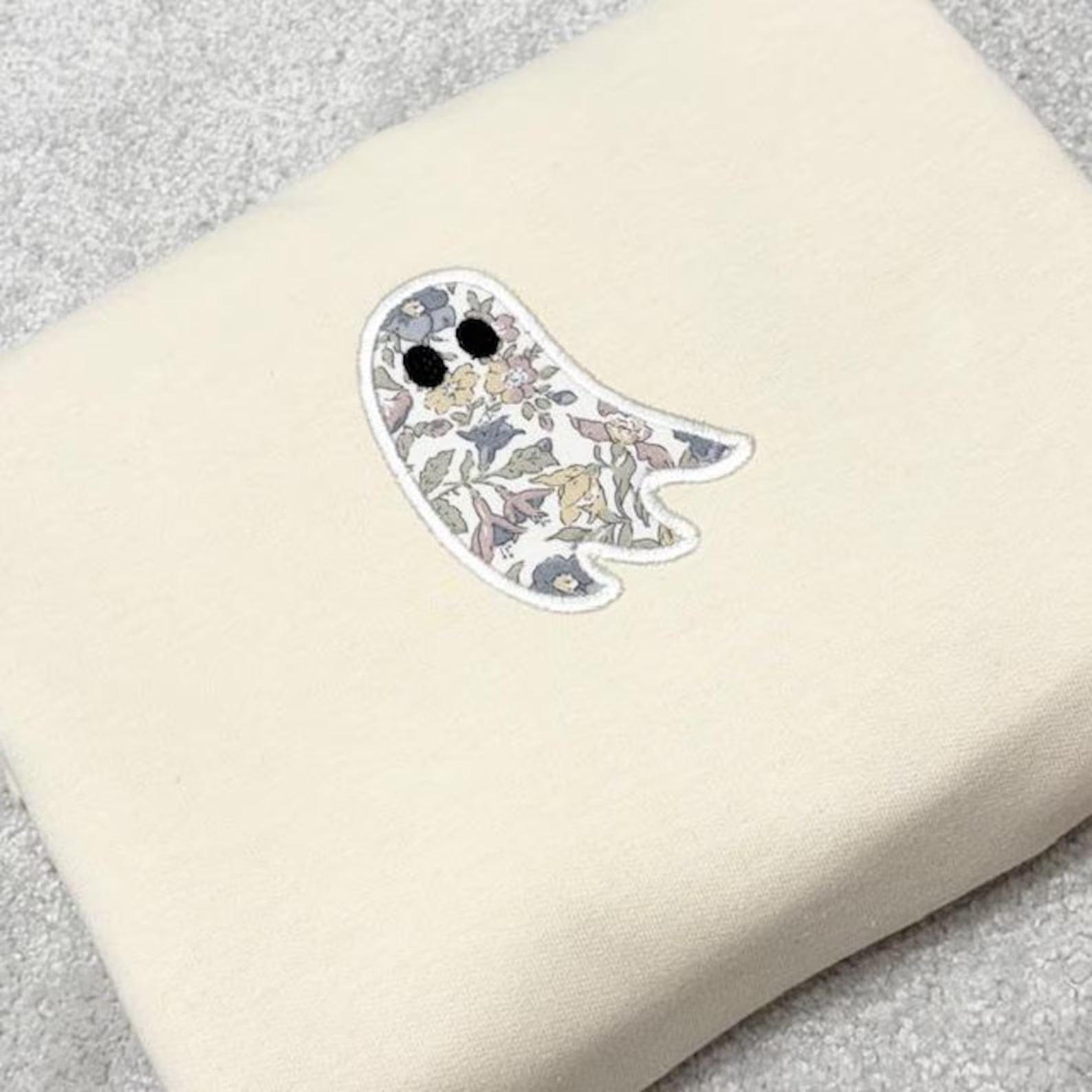 Liberty Fabric floral ghost appliqued onto a cream coloured sweatshirt.