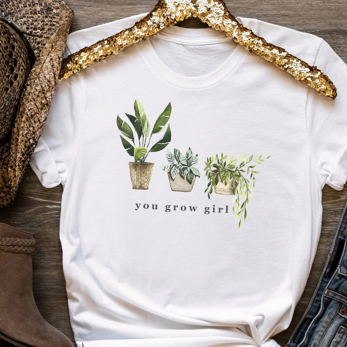 White t-shirt with plant illustrations and 'you grow girl' text 