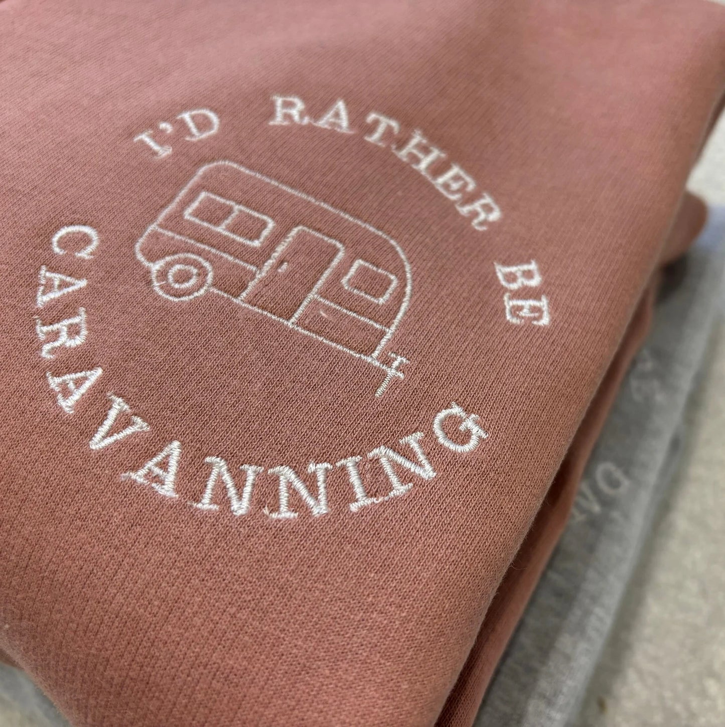 Dusky Pink sweatshirt with 'I'd Rather Be Caravanning' embroidered in a circle with a caravan inside.