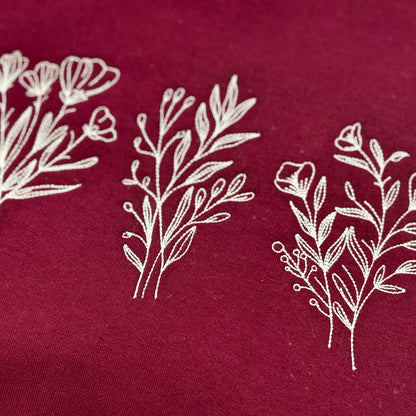 White floral and leaf patterns on a red fabric background