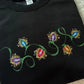 Black sweatshirt with colourful embroidered Christmas light bulbs