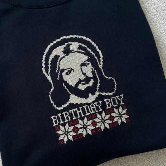 Navy Sweatshirt with a cross-stitch graphic of a Jesus and 'Birthday Boy' text underneath.