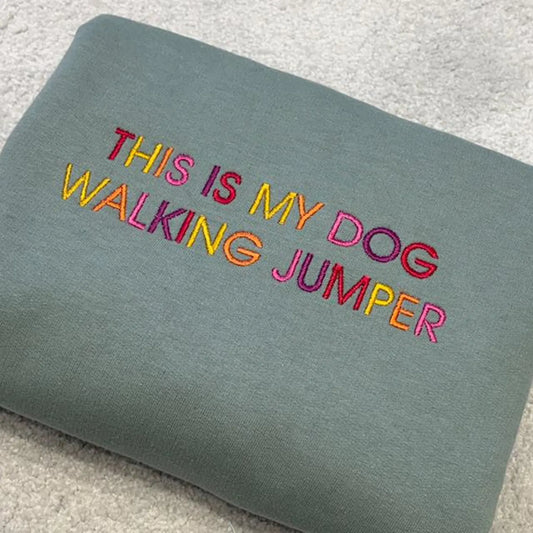 This is My Dog Walking Jumper embroidered onto a green sweatshirt in rainbow colours.
